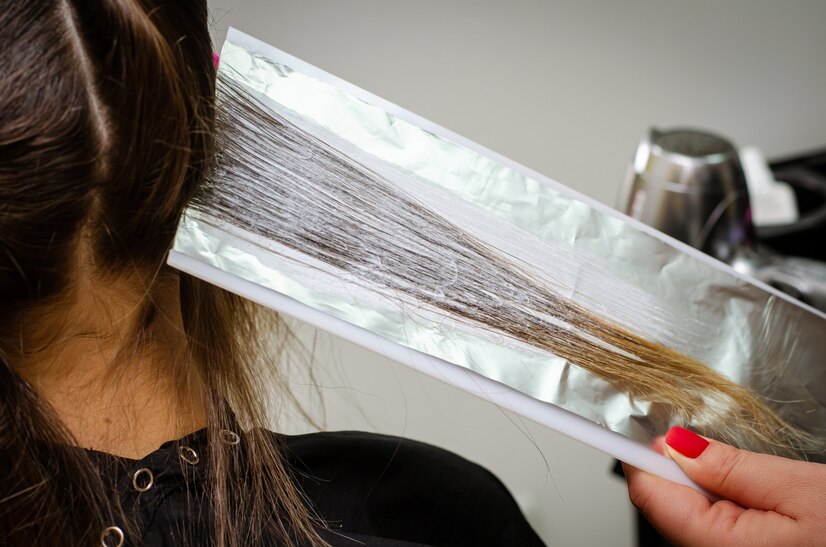 process-applying-bleaching-powder-clients-hair-wrapping-into-foil